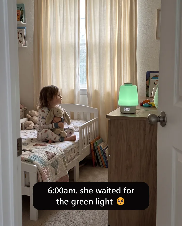 Spec ad for Hatch styled as a parent’s story. A toddler hugging a stuffed bunny sits on her bed watching a Hatch Baby glow green, with the caption: 6:00am. she waited for the green light.